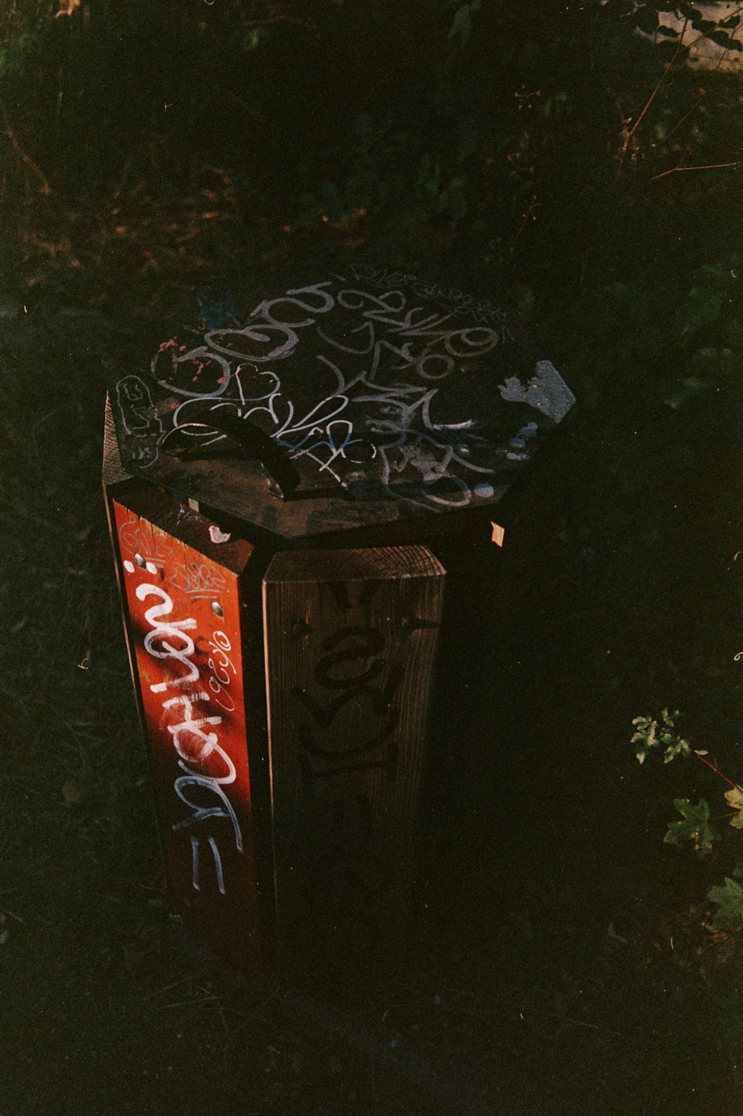 Those object you don't look at, part of our mundane life, populating our spaces with purpose. Take a moment to stop on them, maybe the light hitting it right, maybe the shape is odd, or maybe it got though hands of some street artists, but maybe it's not that bland. And when you got all of those, then more than mundane it become, like this trash you shouldn't care. But covered in scribbles, a red plank caught in warm light, it's actually really nice.