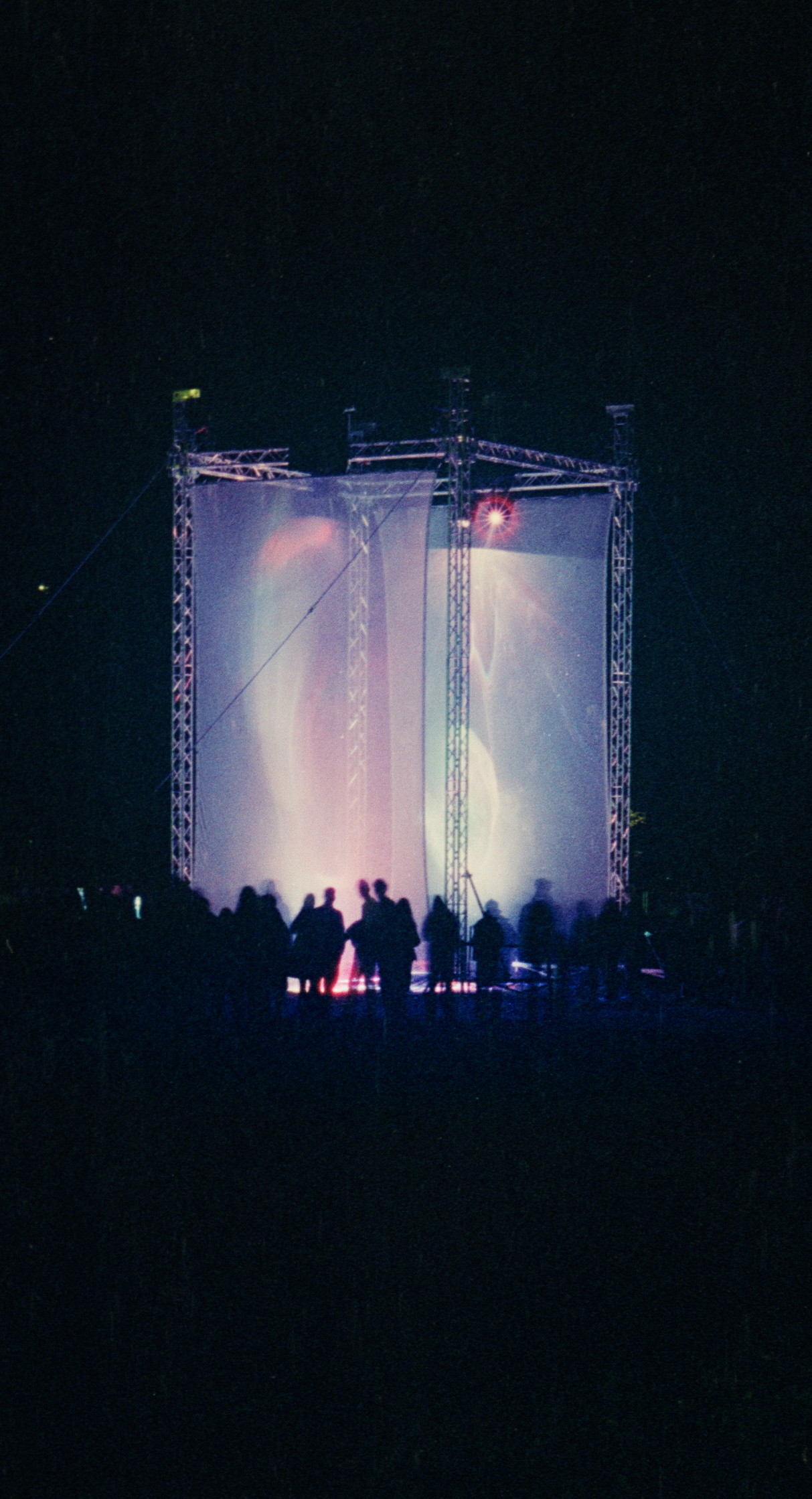 A big structure of light effect was placed in a middle of the park field. Coloured waves of light slowing moving inside. It's pitch black all around so hard to judge the scale of the installation. But as people wanders around the display, their shadowy silhouette hint us at large display. Go on, sit down for a few minutes in the wet grass; and let your mind lost itself in the hypnotic waves of light it emits.