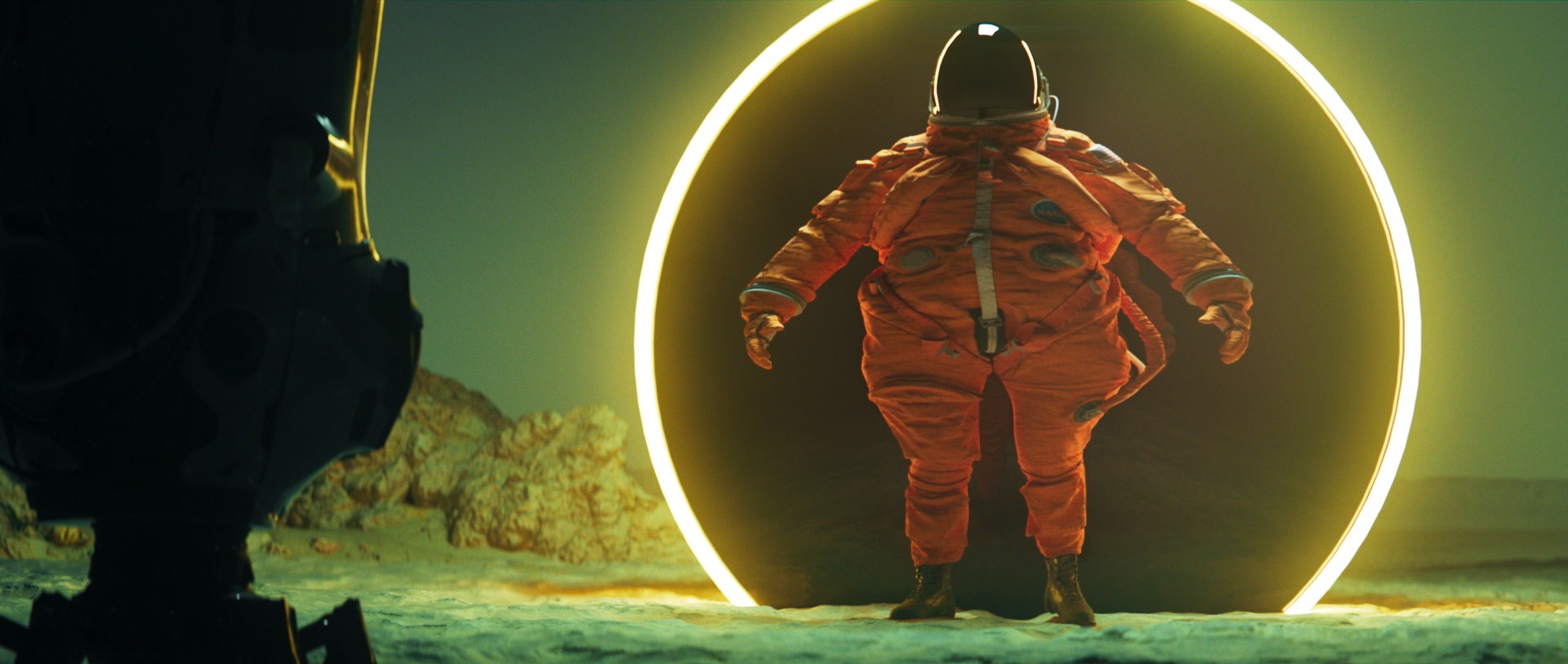 A comically large astronaut is emerging of a kind of light ring while some sort of robot stare at him.